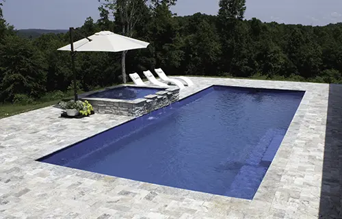 Leisure Pools The Grand rectangular fiberglass composite pool for lounging, installed by Leisure Pools Northwest Ohio